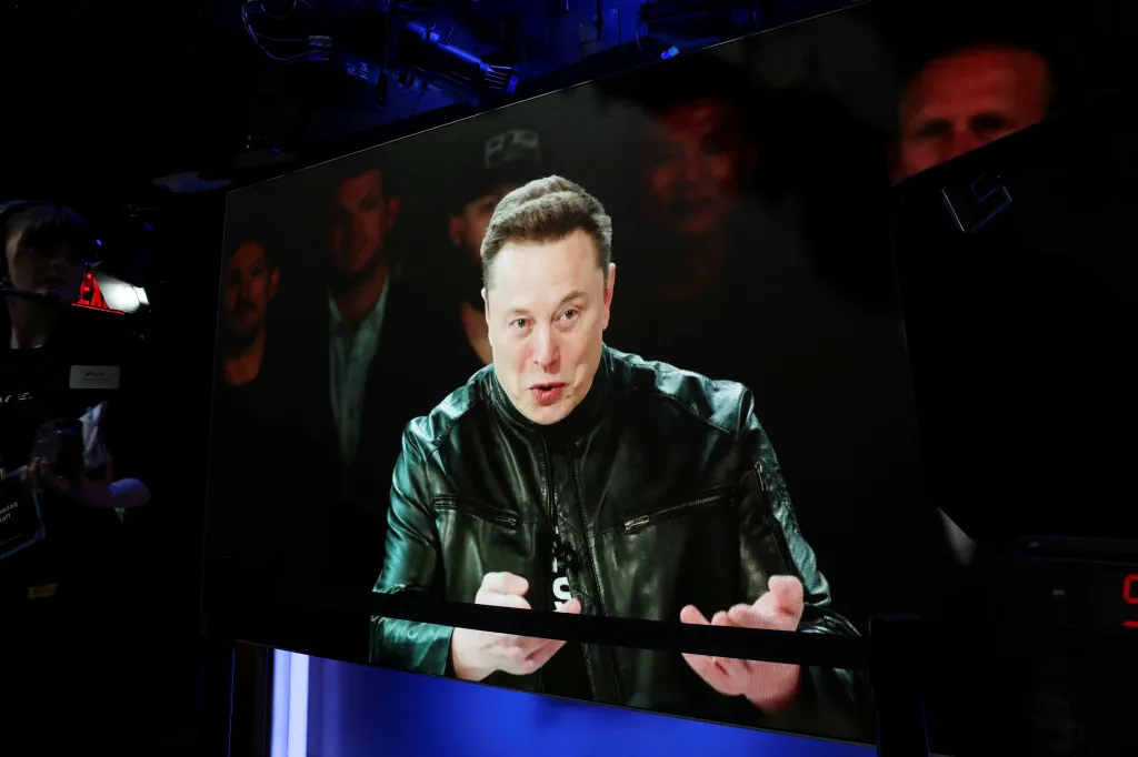 Elon Musk speaking via videolink at the Nasdaq MarketSite IPO.