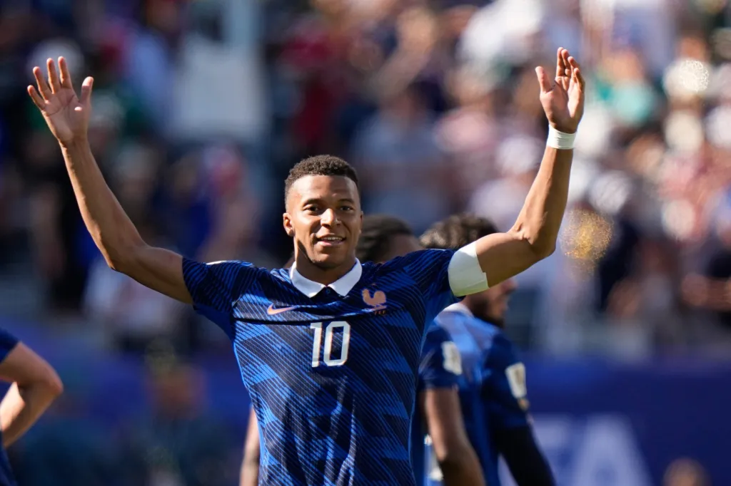 Kylian Mbappe celebrating during a World Cup Group I soccer match.