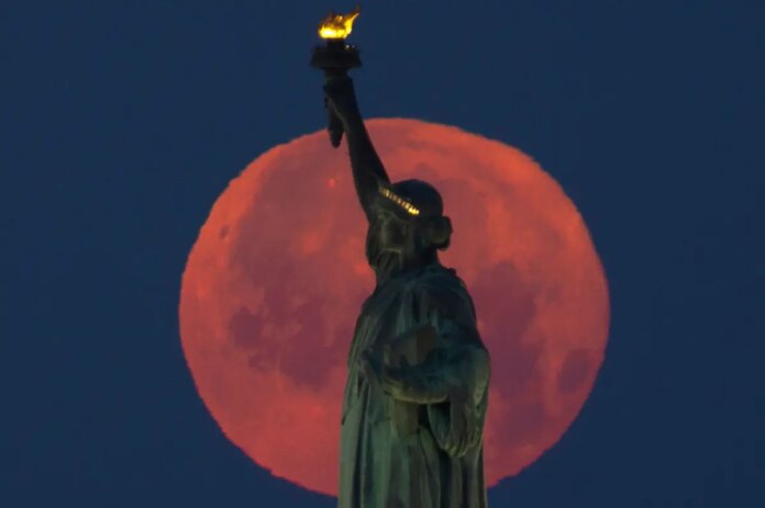full-strawberry-moon-sets-behind-132697381.jpg