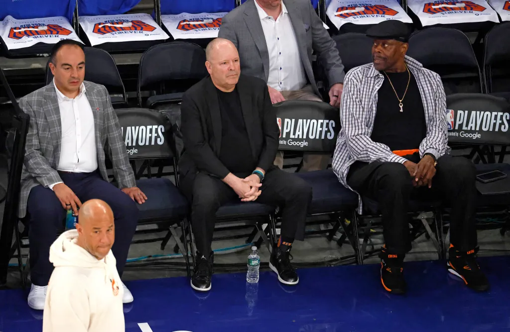 Gersson Rosas, Leon Rose, and Patrick Ewing watch warm-ups before Game 1 of the Eastern Conference Finals.