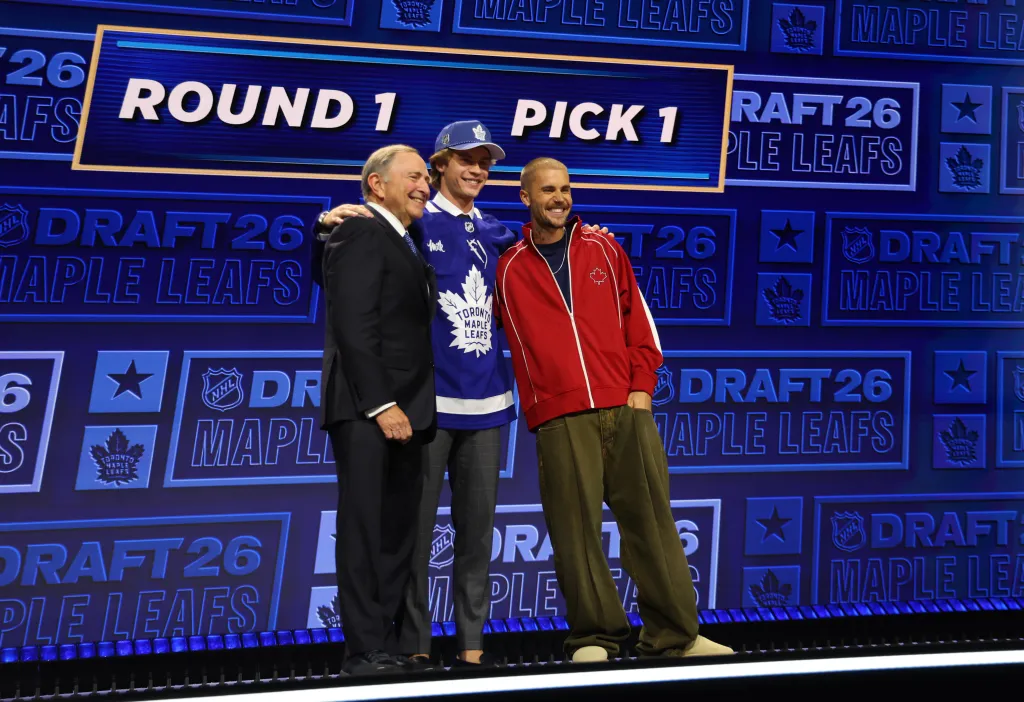 NHL Commissioner Gary Bettman, Gavin McKenna of the Toronto Maple Leafs, and singer Justin Bieber pose for a photo at the 2026 NHL Draft.