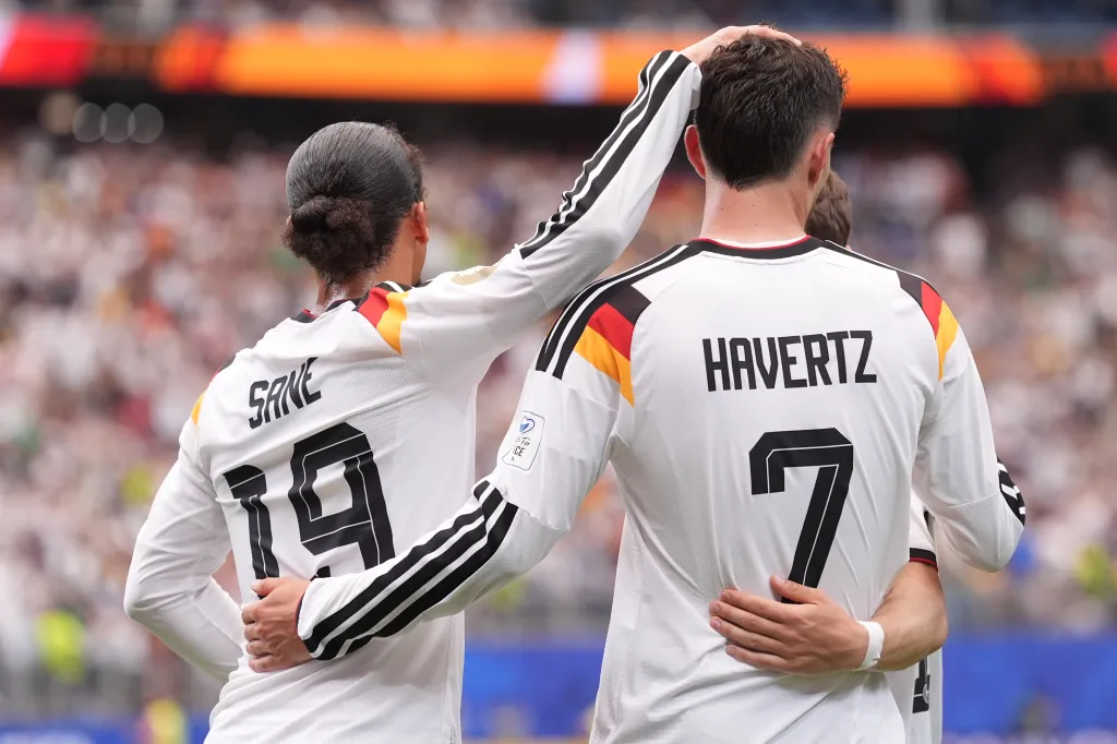 Germany's Leroy Sane and Kai Havertz celebrate after scoring the seventh goal during a World Cup Group E soccer match.
