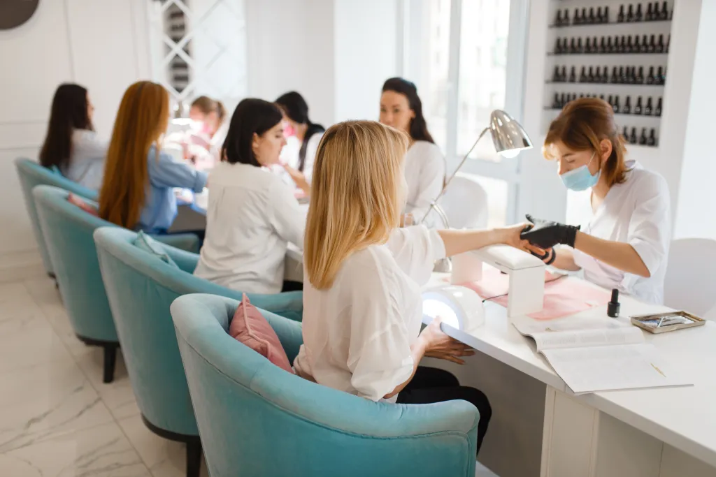Group of girlfriends having manicures in a beauty salon.