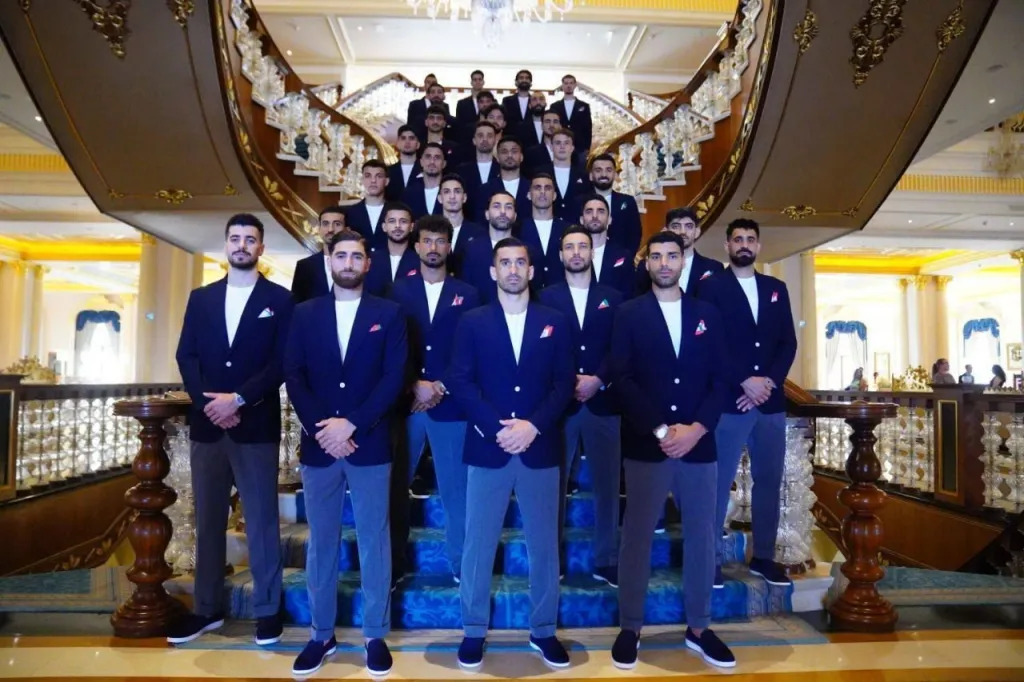 Iranian national soccer team members pose for a photo in suits before departing for the FIFA World Cup 2026.