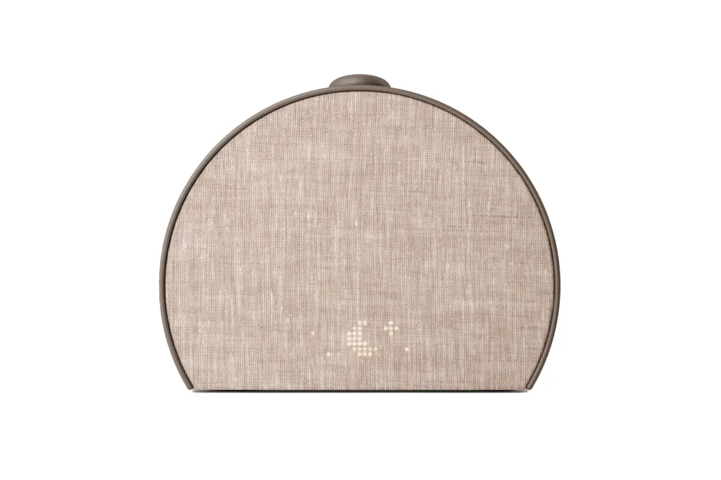 Beige fabric speaker with illuminated crescent moon icon.