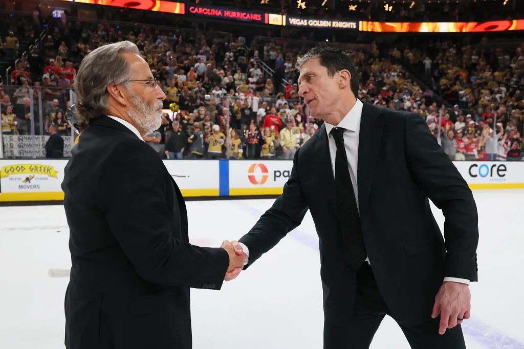 Golden Knights head coach John Tortorella (l.) and Hurricanes head coach Rod Brind'Amour (r.) shake hands after Carolina wins the Stanley Cup on June 14, 2026.