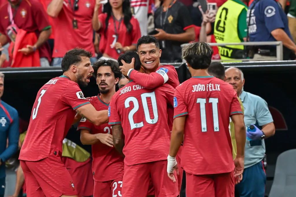 Cristiano Ronaldo celebrating with teammates after scoring a goal during a match between Portugal and Uzbekistan at the FIFA World Cup 2026.