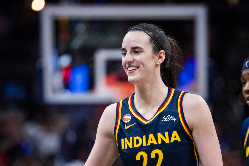 Caitlin Clark smiling in her Indiana Fever uniform.