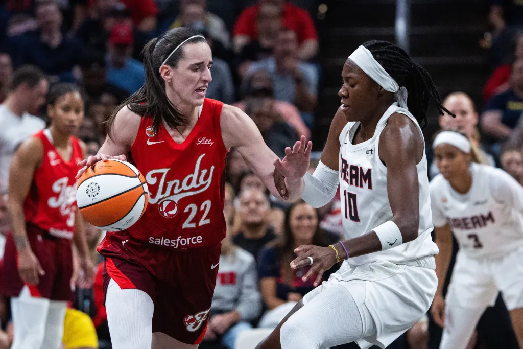 Caitlin Clark of the Indiana Fever dribbles the ball against Rhyne Howard of the Atlanta Dream.
