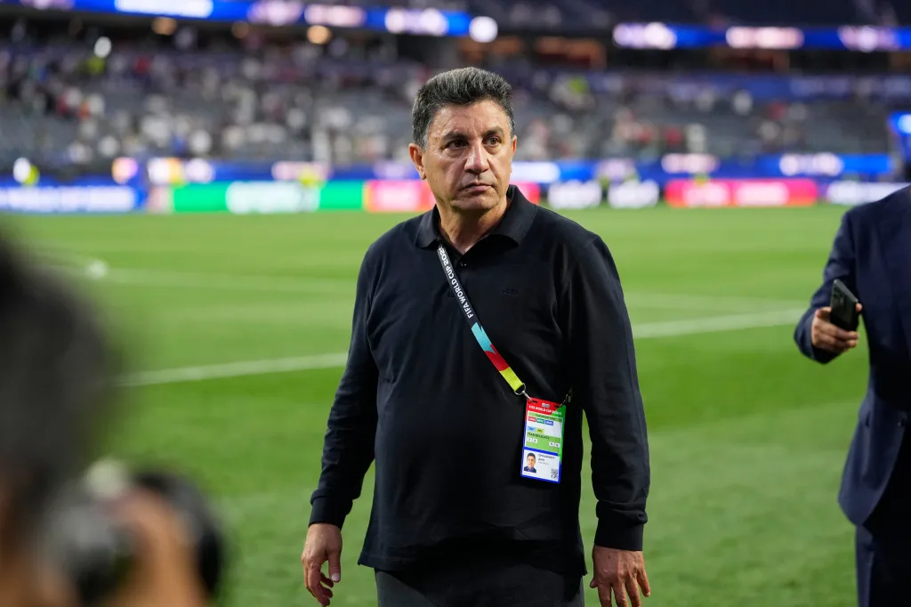 Iran head coach Amir Ghalenoei walks off the field during a World Cup Group G soccer match.