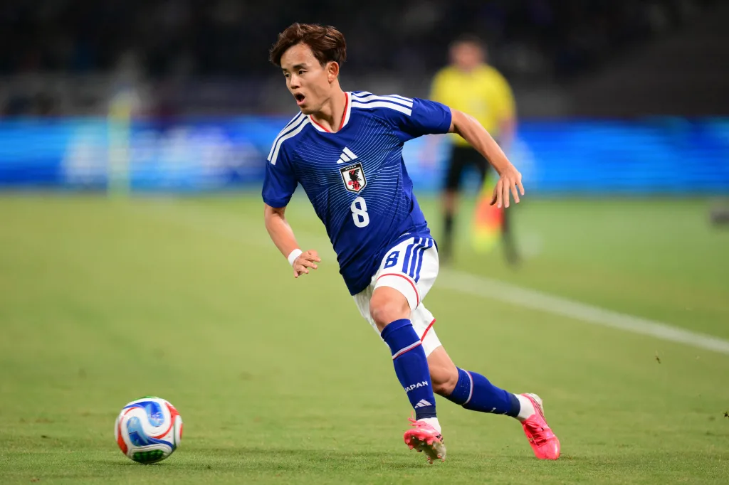 Japan's Takefusa Kubo controls the ball during a football match.