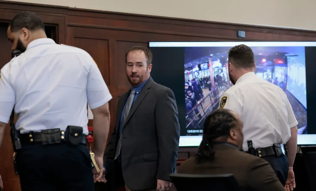 Joseph Piemonte in a suit looking at Alvin Campbell Jr. in court.