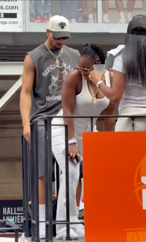 Josh Hart and his wife on a balcony.