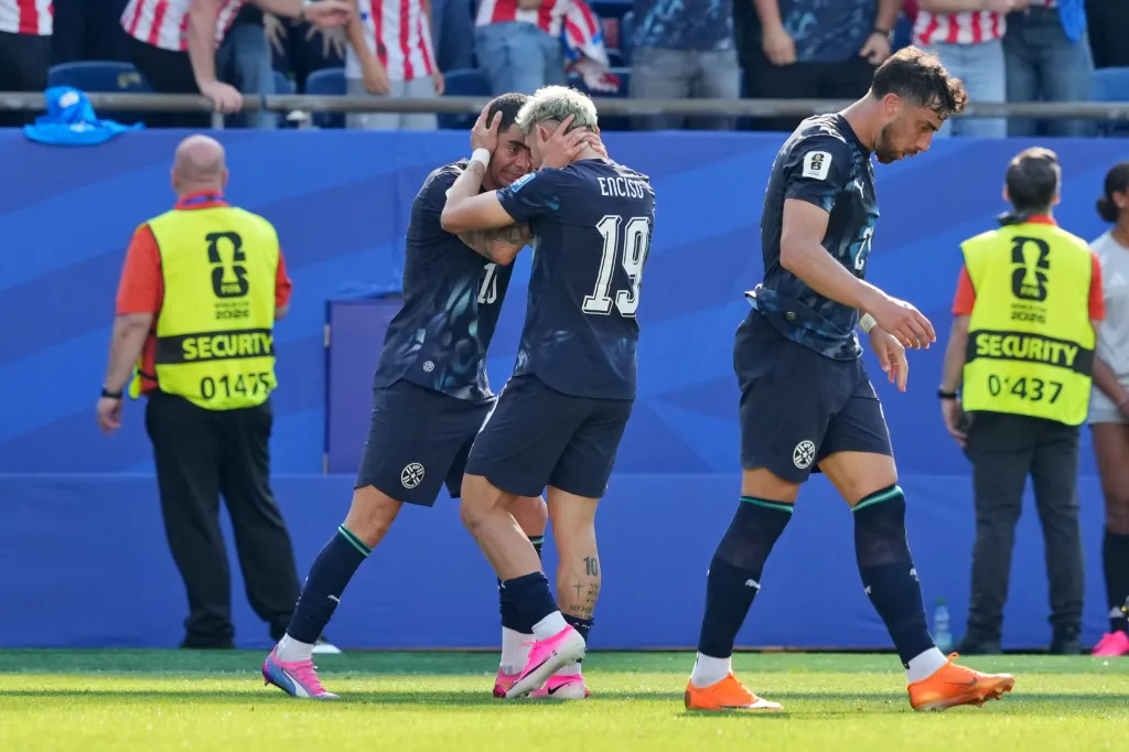 Julio Enciso of Paraguay celebrates a goal with Miguel Almiron of Paraguay during a FIFA World Cup match.