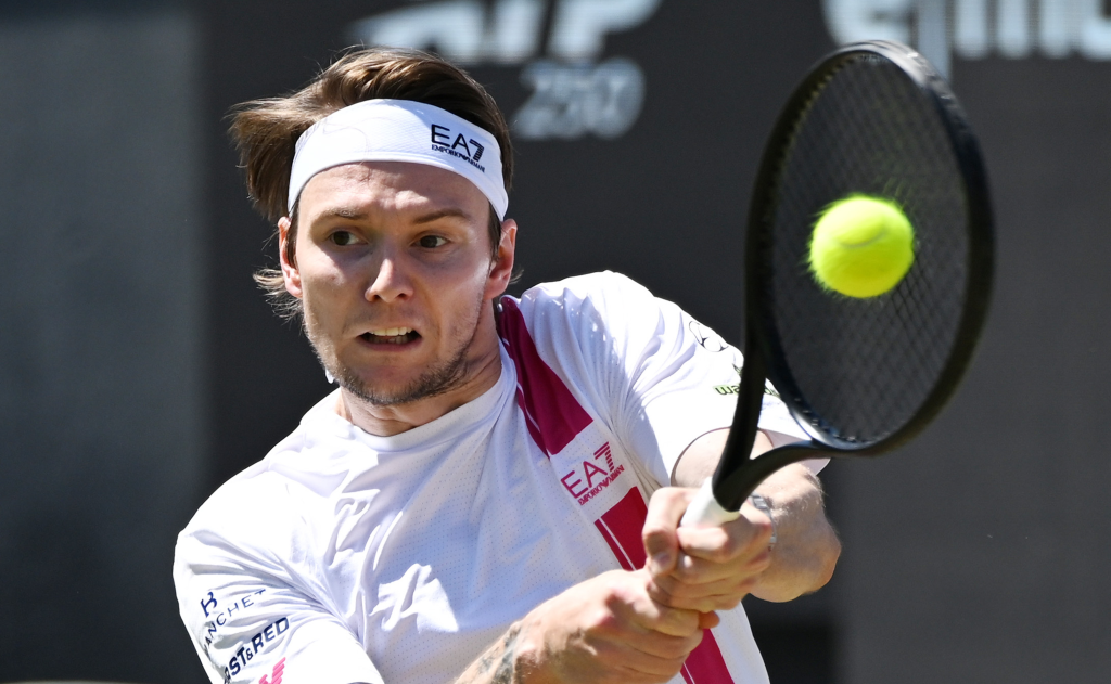 Kazakhstan's Alexander Bublik hitting a tennis ball during a men's singles semifinal match.