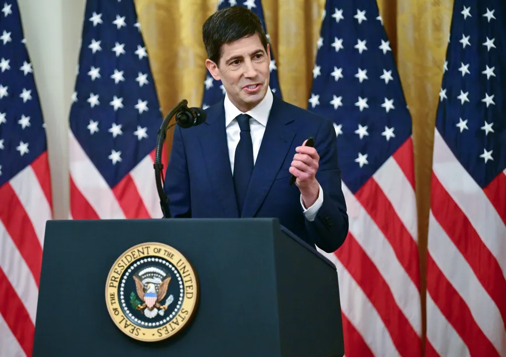 Kevin Warsh, sworn in as Federal Reserve Chair, speaks at a podium with the Seal of the President of the United States.