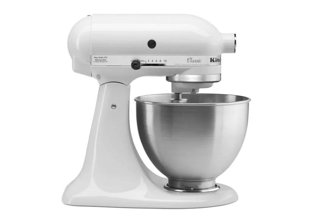 A white KitchenAid Classic stand mixer with a stainless steel bowl on a white background.