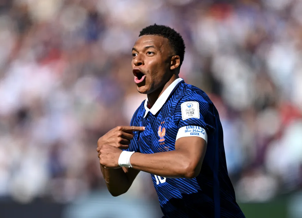 Kylian Mbappe #10 of France celebrates scoring against Senegal.