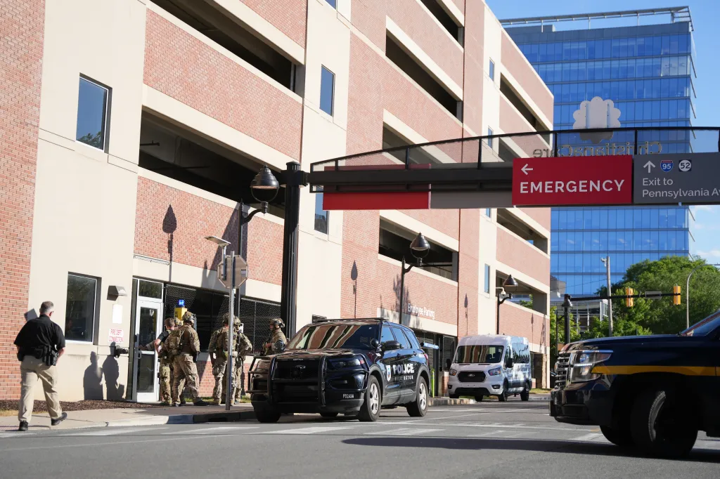 Law enforcement personnel gather outside Wilmington Hospital after a shooting.