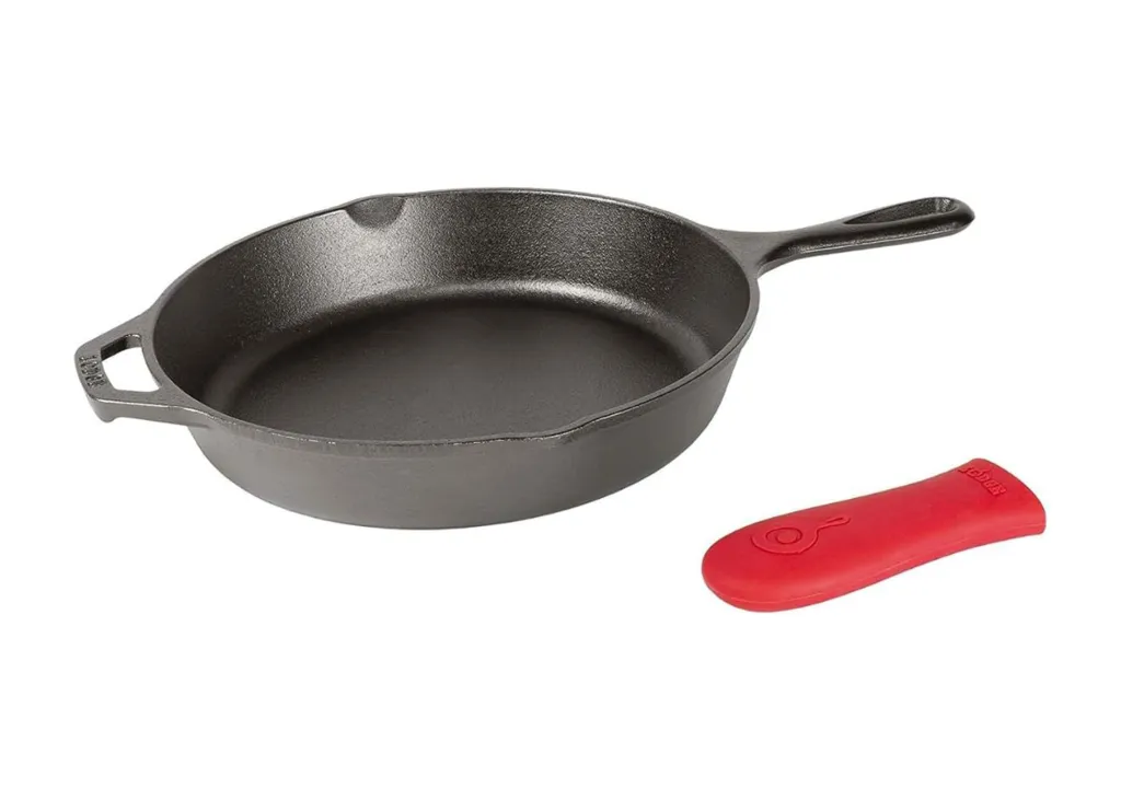 A Lodge cast iron skillet with a red silicone hot handle holder.
