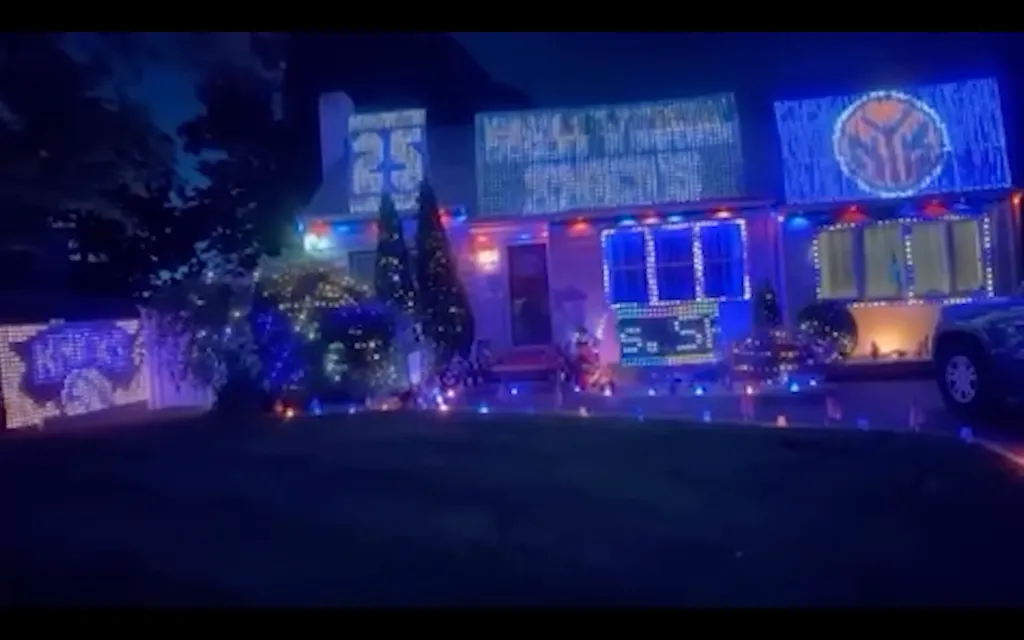 A Long Island house decorated with blue and orange lights and signs for the NBA finals.