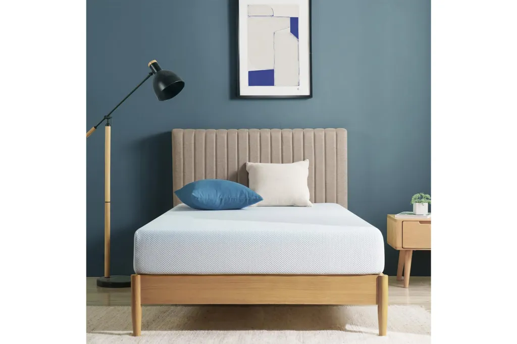Mattress on bed frame in blue room