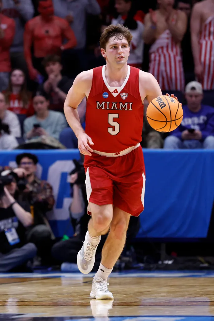 Miami RedHawks guard Peter Suder (5) dribbles the ball.