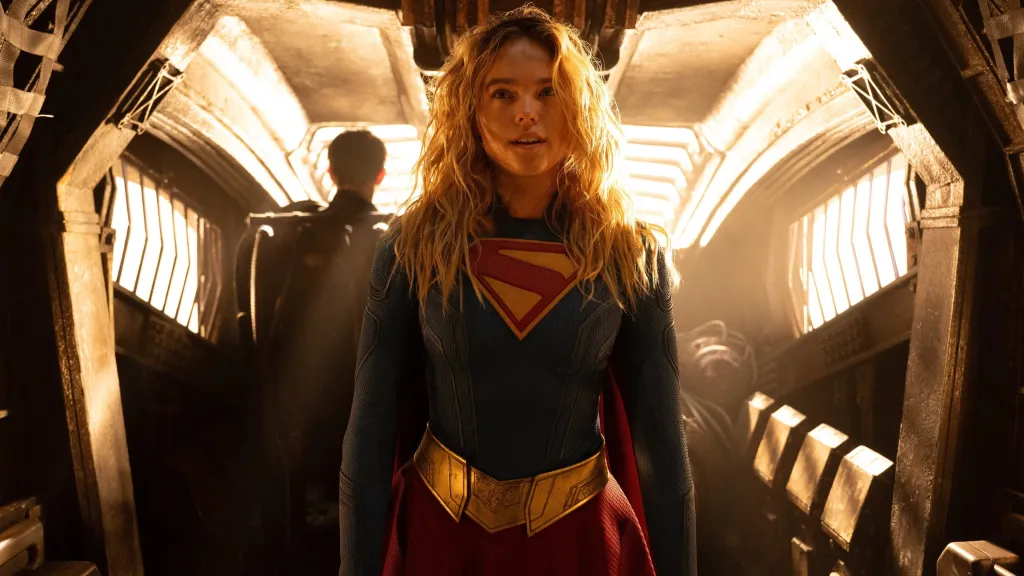 Milly Alcock as Supergirl, Kara Zor-El, in her Supergirl suit with the signature red, blue, and gold colors.