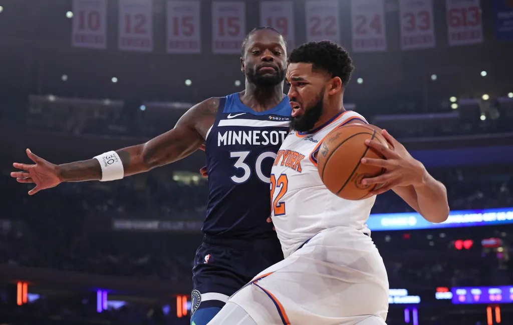 New York Knicks center Karl-Anthony Towns drives to the basket as Timberwolves Julius Randle defends.