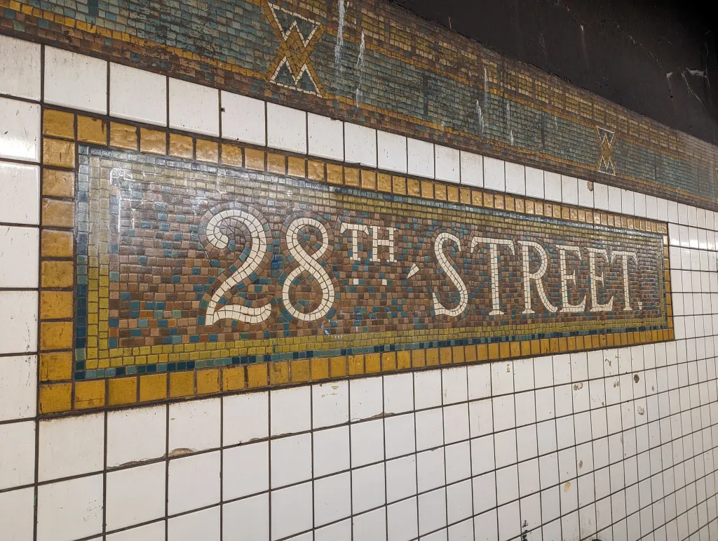 Mosaic subway sign for 28th Street Station in New York City.