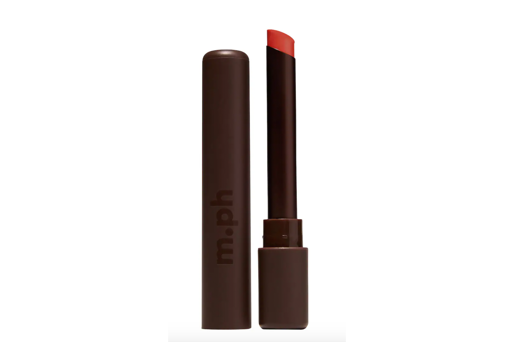 An open tube of red-orange lipstick stands next to its dark brown cap.