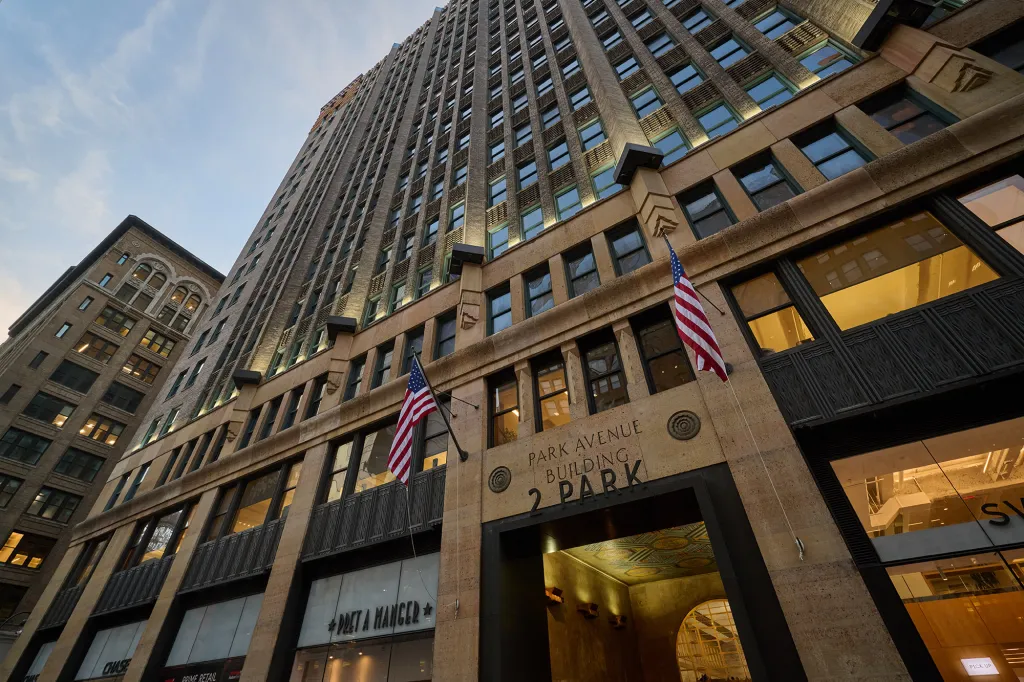 The Park Avenue Building at 2 Park Avenue, with flags outside the building.