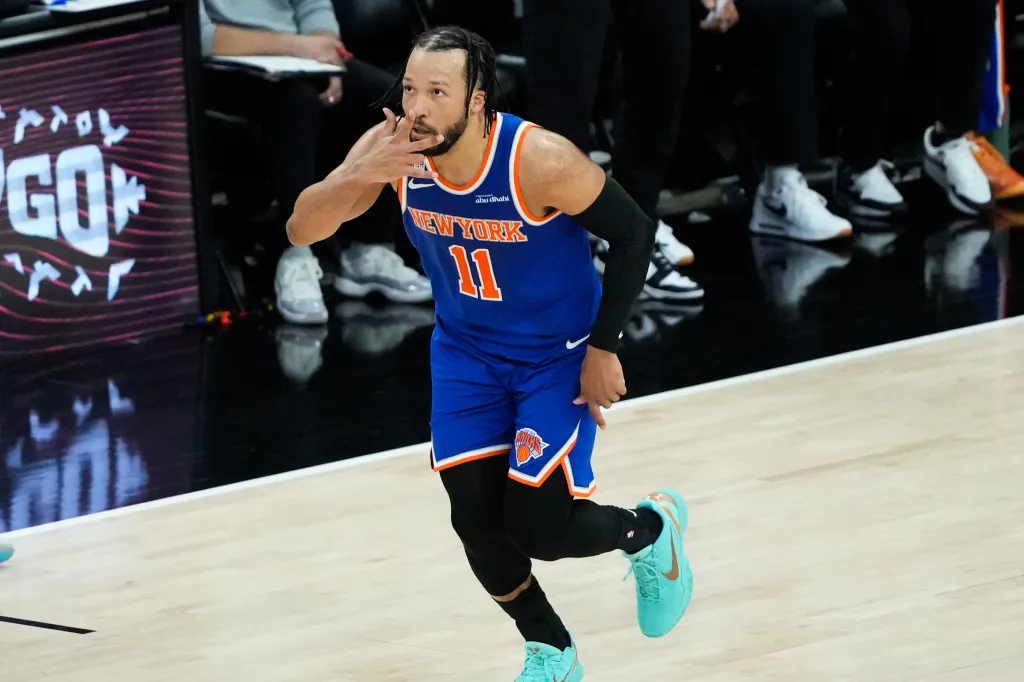 Jalen Brunson in a New York Knicks uniform, gesturing with his hand.