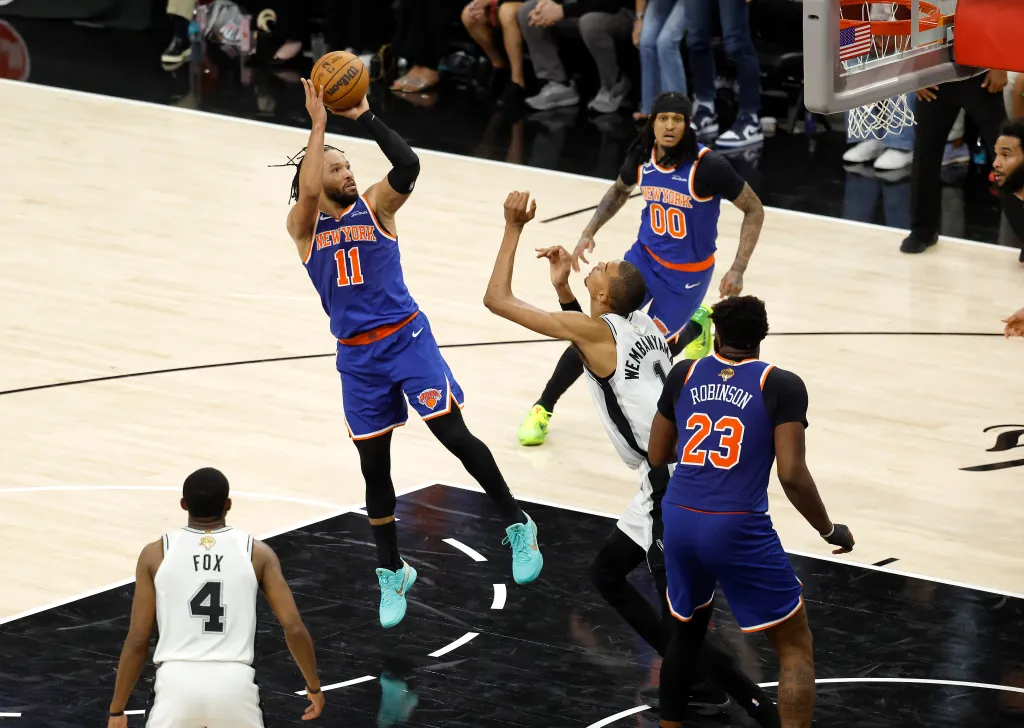 New York Knicks guard Jalen Brunson (11) shoots over San Antonio Spurs forward Victor Wembanyama (1) during Game 5 of the 2026 NBA Finals.