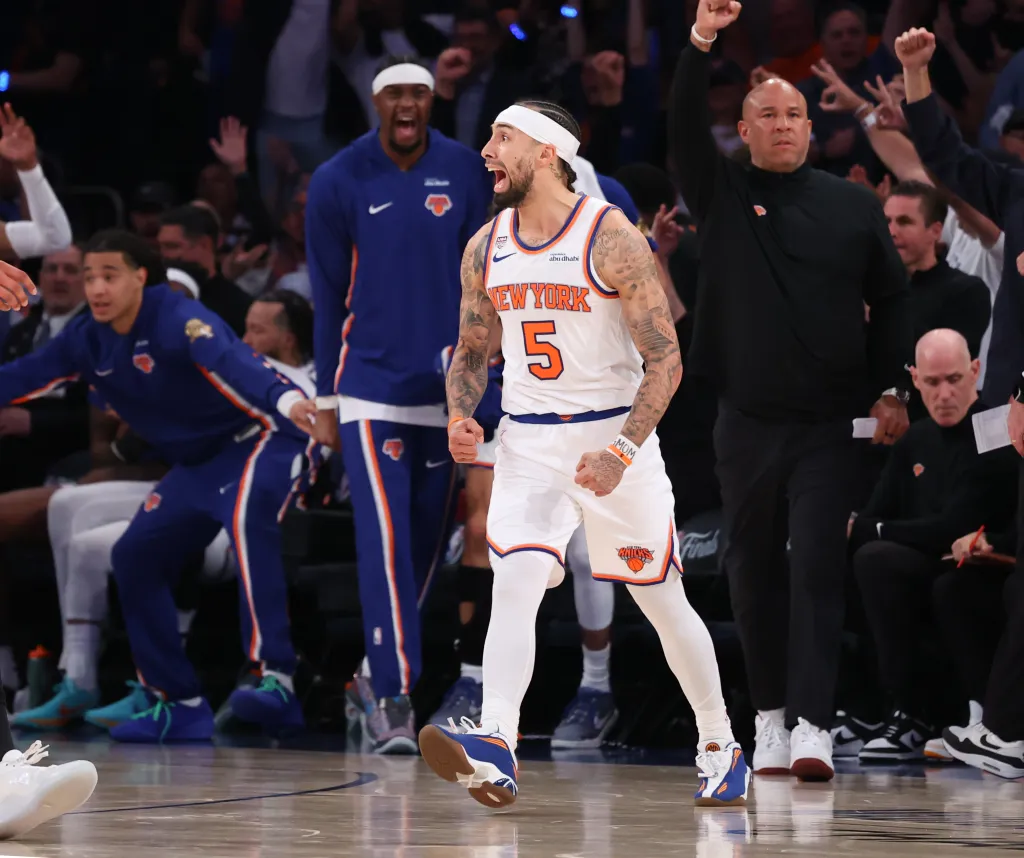New York Knicks guard Jose Alvarado dribbling the ball against San Antonio Spurs guard Stephon Castle.