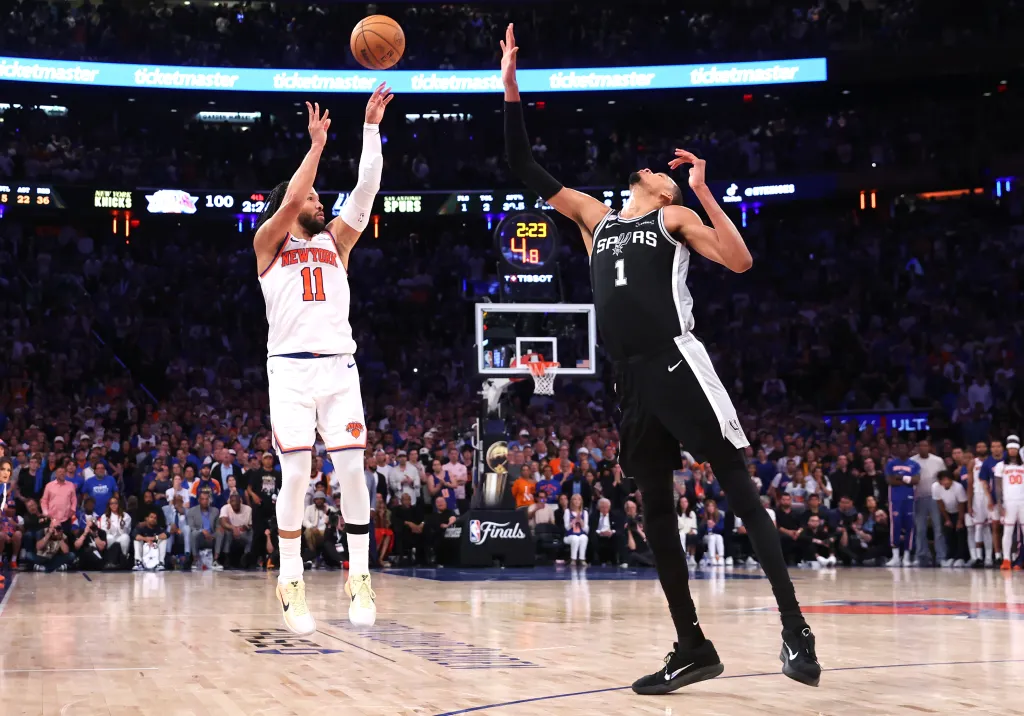Jalen Brunson #11 sinks a three-point shot over San Antonio Spurs forward Victor Wembanyama #1 to bring the Knicks within one during the fourth quarter. 