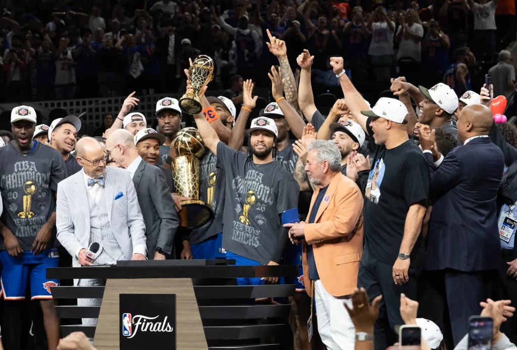 New York Knicks guard Jalen Brunson holds up the MVP trophy after winning the NBA Championship.