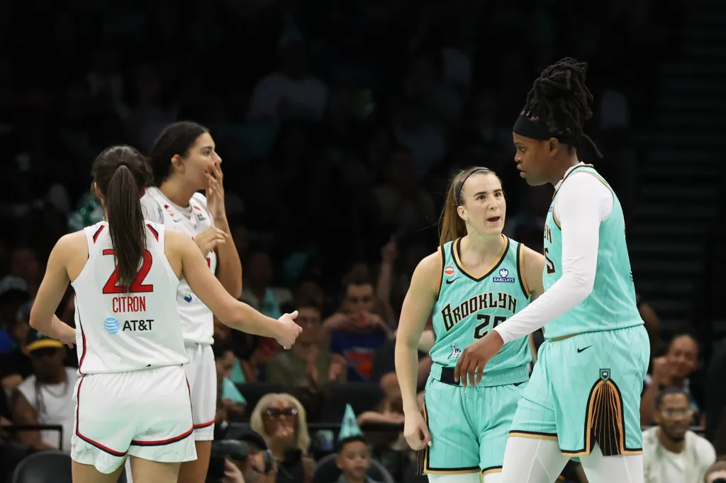 Sabrina Ionescu (20) celebrates with Jonquel Jones (35) during a WNBA basketball game.