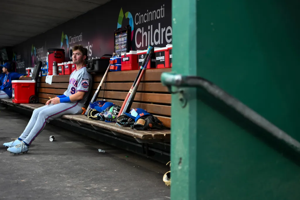 New York Mets outfielder A.J. Ewing sits in the dugout before the game against the Cincinnati Reds.