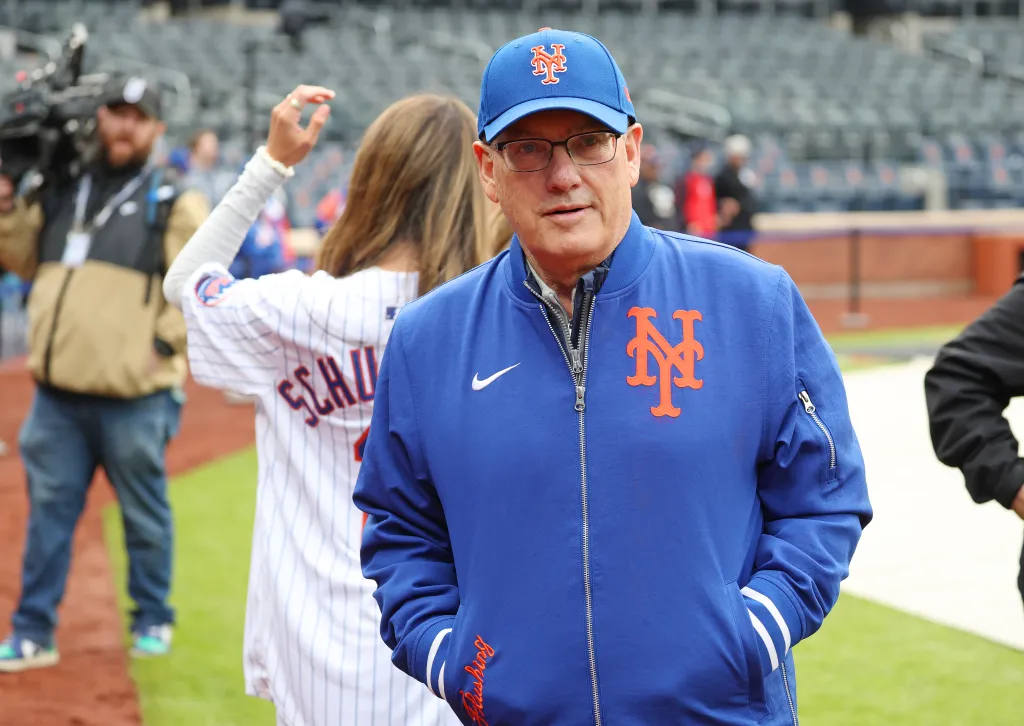 Steve Cohen, owner of the New York Mets, wears a blue Mets cap and jacket.