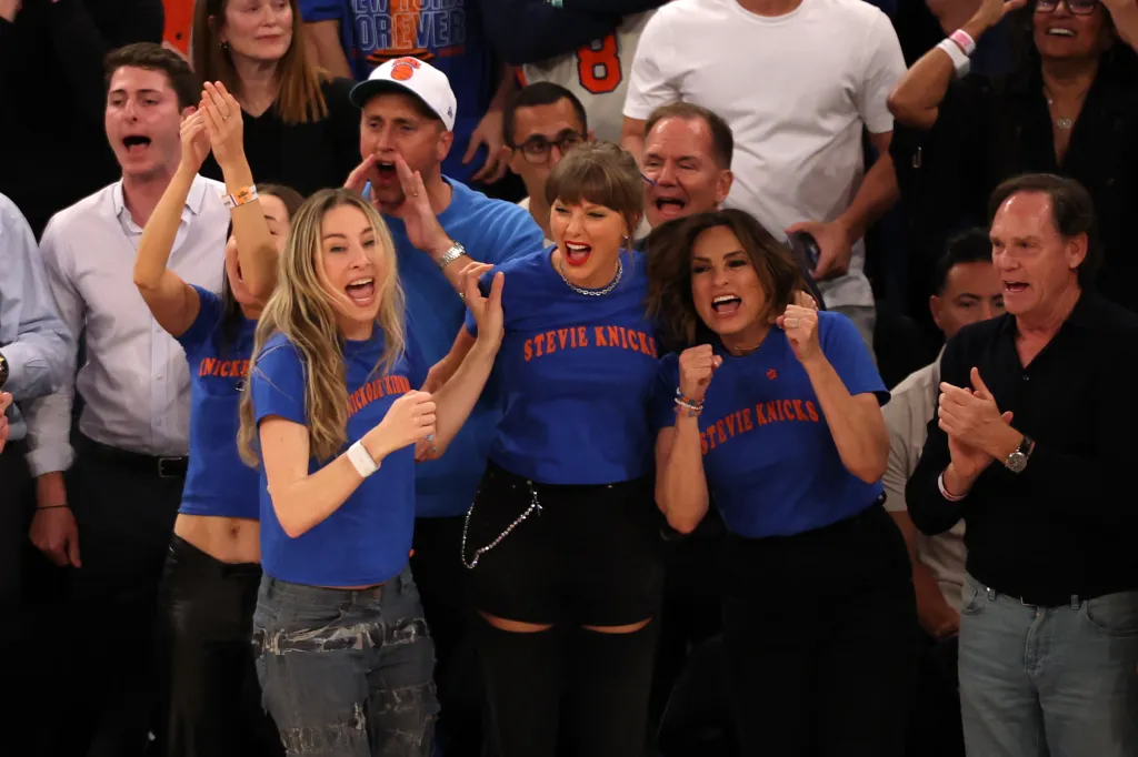 Taylor Swift, Este Haim, and Mariska Hargitay cheering at an NBA game.