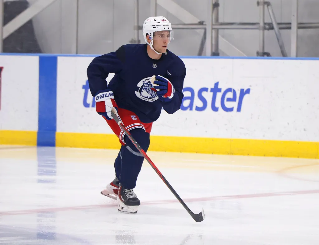 New York Rangers player Liam Greentree (85) skating on ice with a hockey stick during development camp.