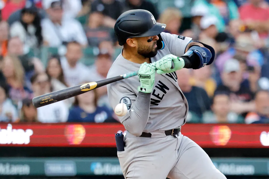 New York Yankees catcher Ali Sanchez being hit by a pitch.