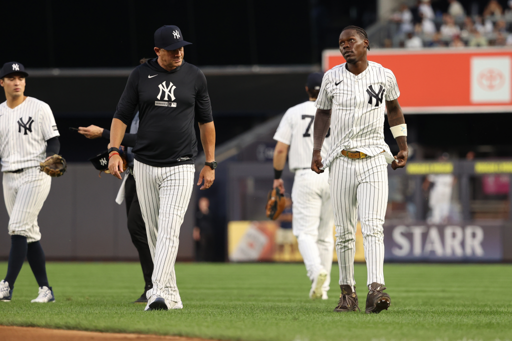 Jazz Chisholm Jr. walking to the dugout after colliding with a teammate.