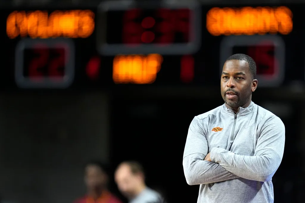 Oklahoma State head coach Mike Boynton observing a basketball game.
