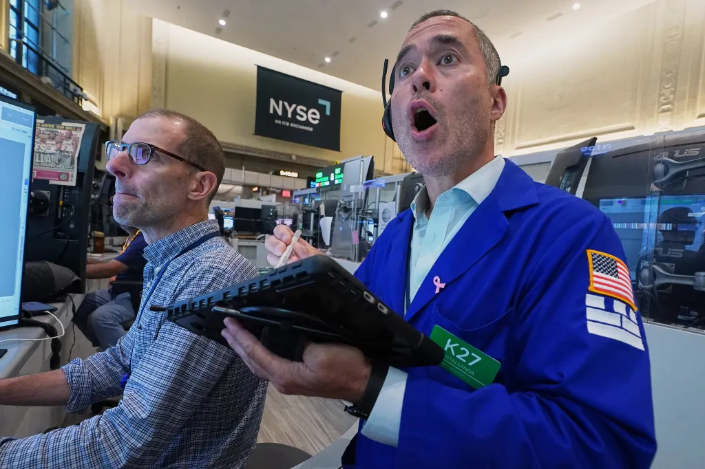 Options trader Justin Kanda, with mouth open, working on the New York Stock Exchange floor.
