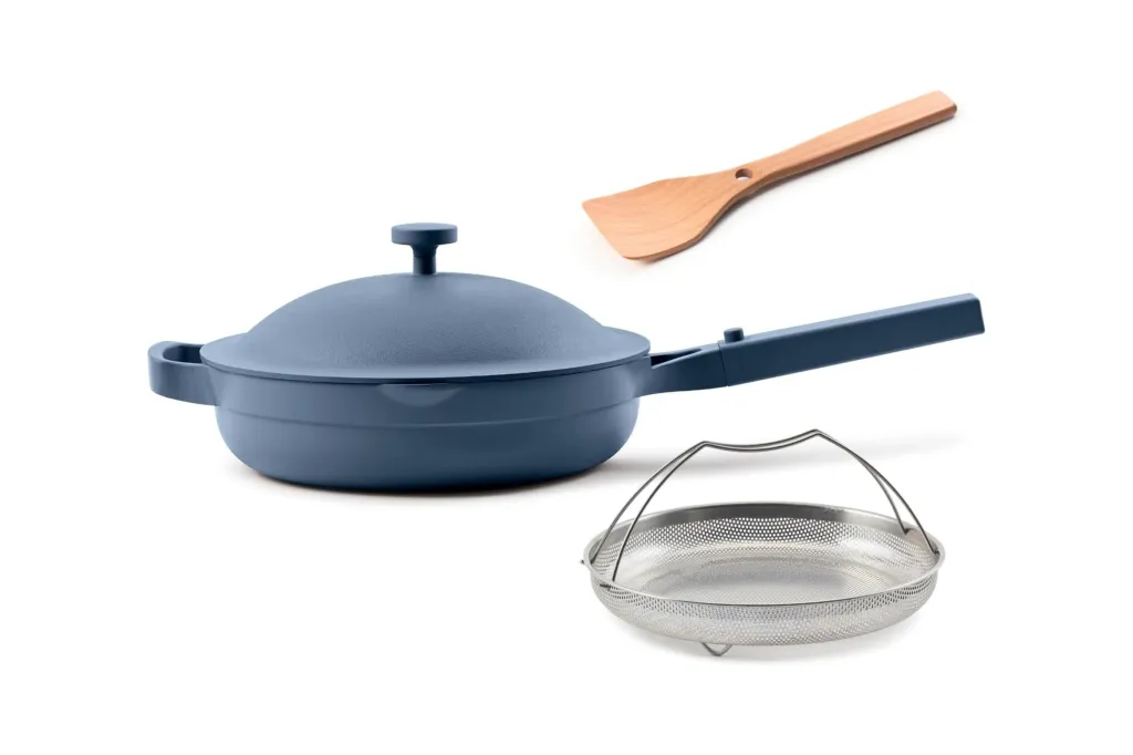 A blue pan with a lid and a metal strainer