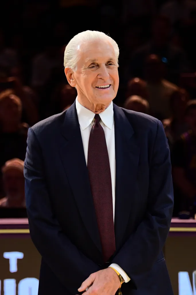 Pat Riley smiling in a suit and tie.