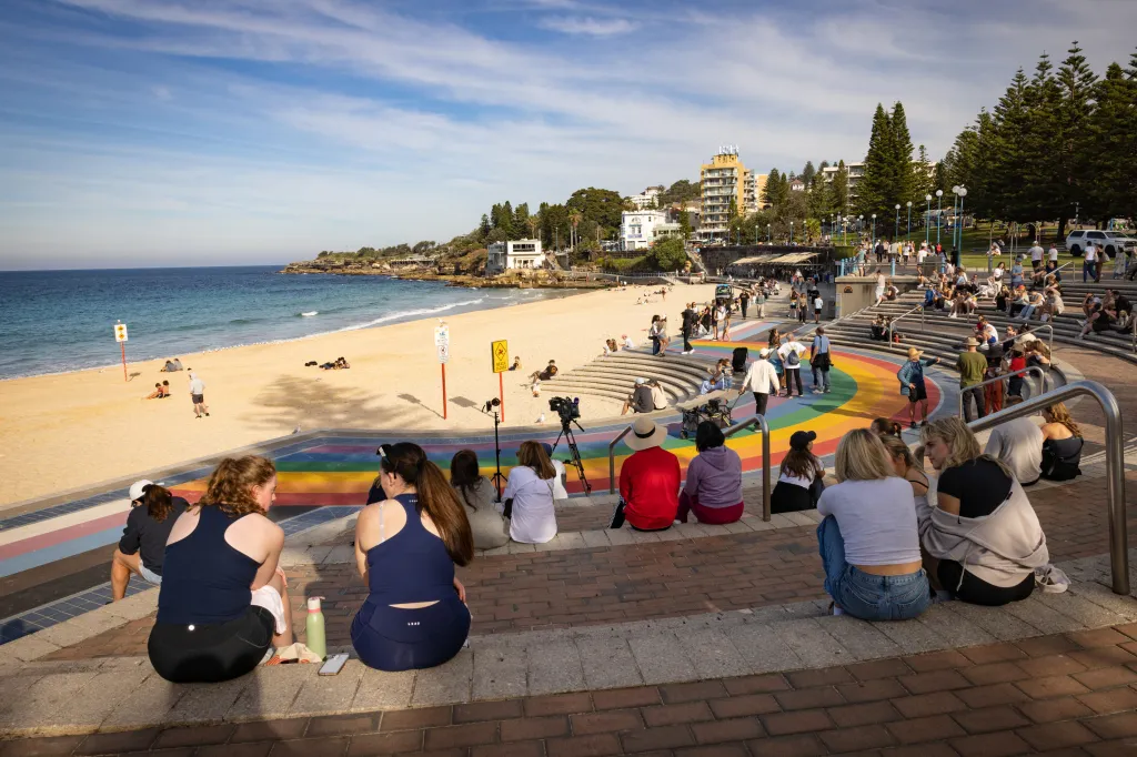 Beachgoers sit on the stairs of Coogee beach after a shark attack in Sydney, Australian, on June 13, 2026.