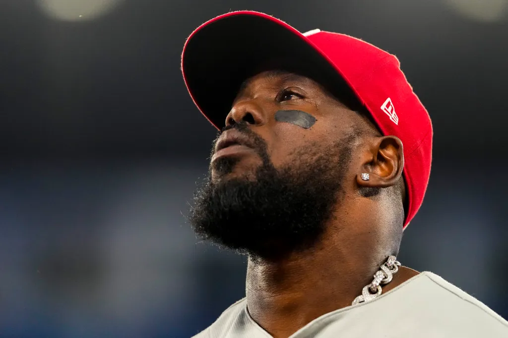 Philadelphia Phillies right fielder Adolis García (53) in profile, wearing a red cap and a diamond chain.